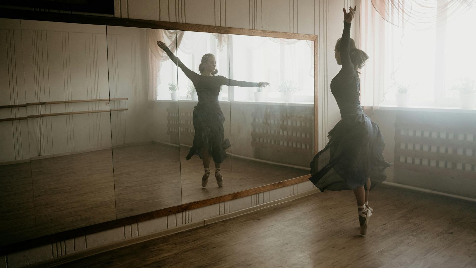 Woman practicing mindful movements in a bright airy room